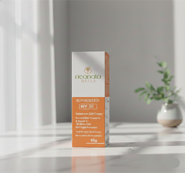 Neonata Belle sunscreen packaging on a reflective surface with a neutral background