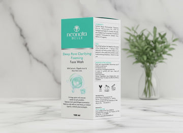 Neocnala Belle face wash box on a marble surface with a plant in the background